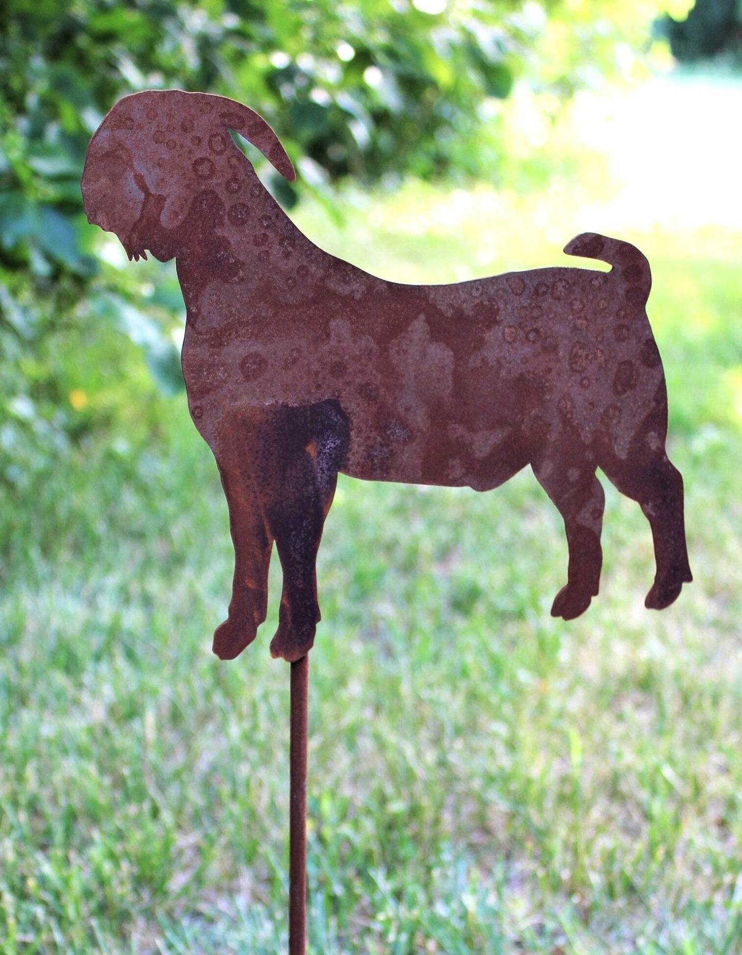 Rusty metal goat garden stake