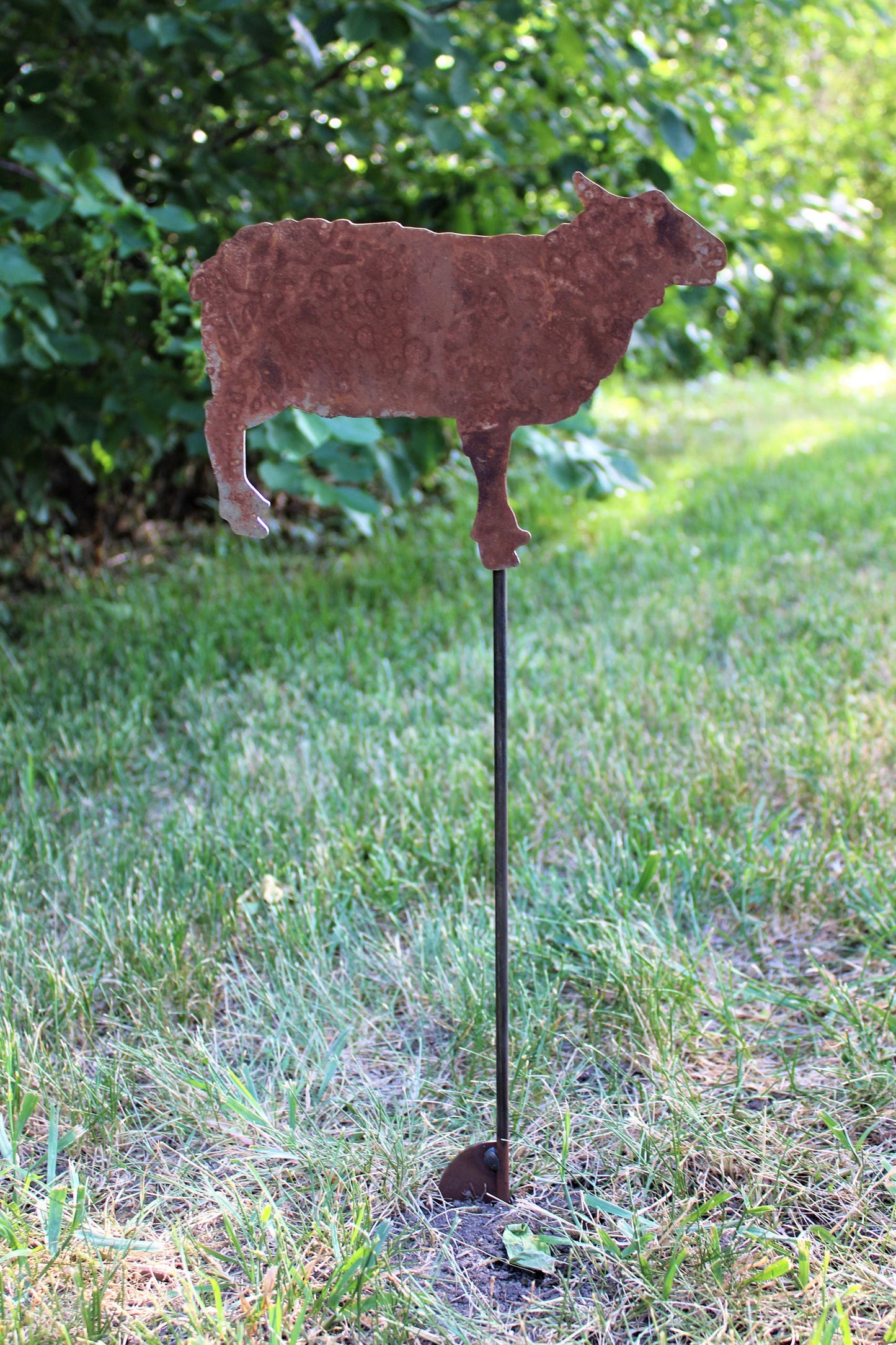 Rusty sheep shaped metal garden stake