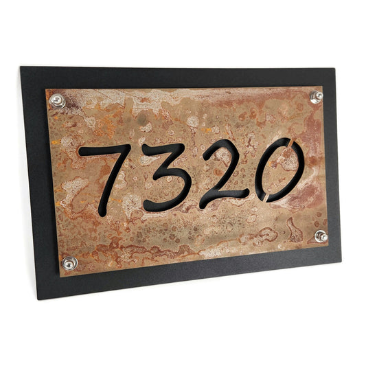 Rust over black metal layered address sign