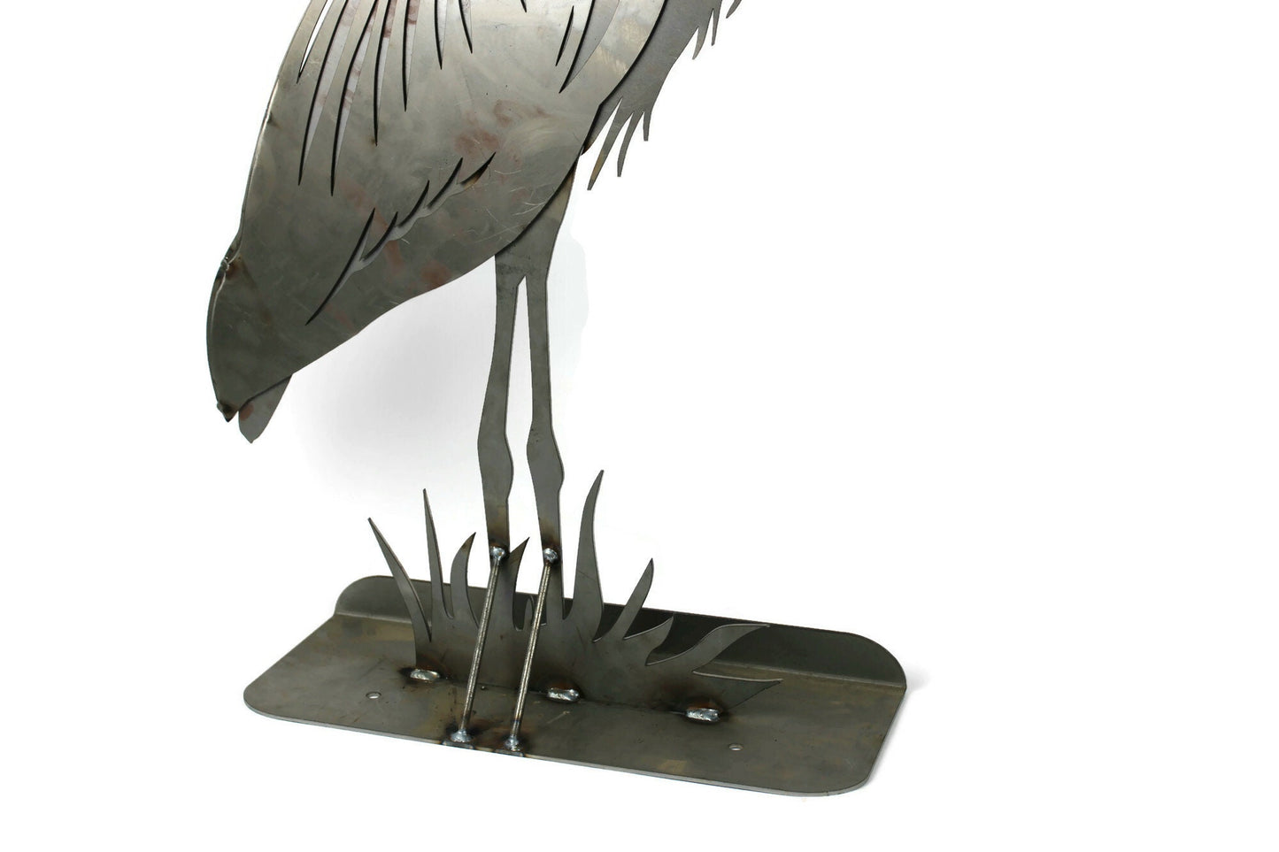 Raw steel metal heron statue base close up