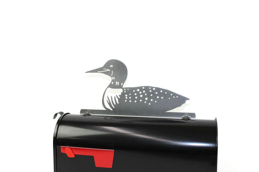 Metallic dark gray loon bird mailbox topper installed on a mailbox.