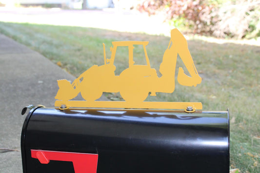 Yellow backhoe mailbox topper installed on a mailbox.