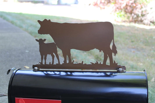 Gloss brown cow and calf standing mailbox topper installed on a mailbox.