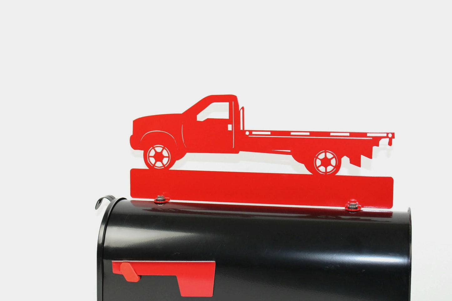 Red flatbed truck mailbox topper installed on a mailbox.