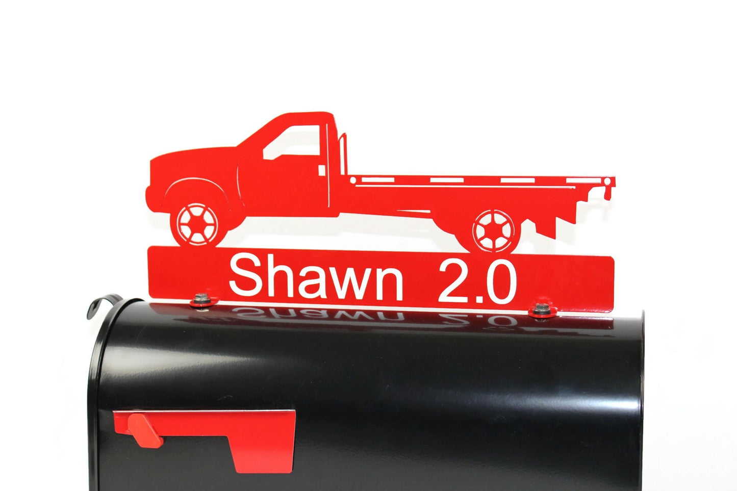 Red flatbed truck mailbox topper with name installed on a mailbox.