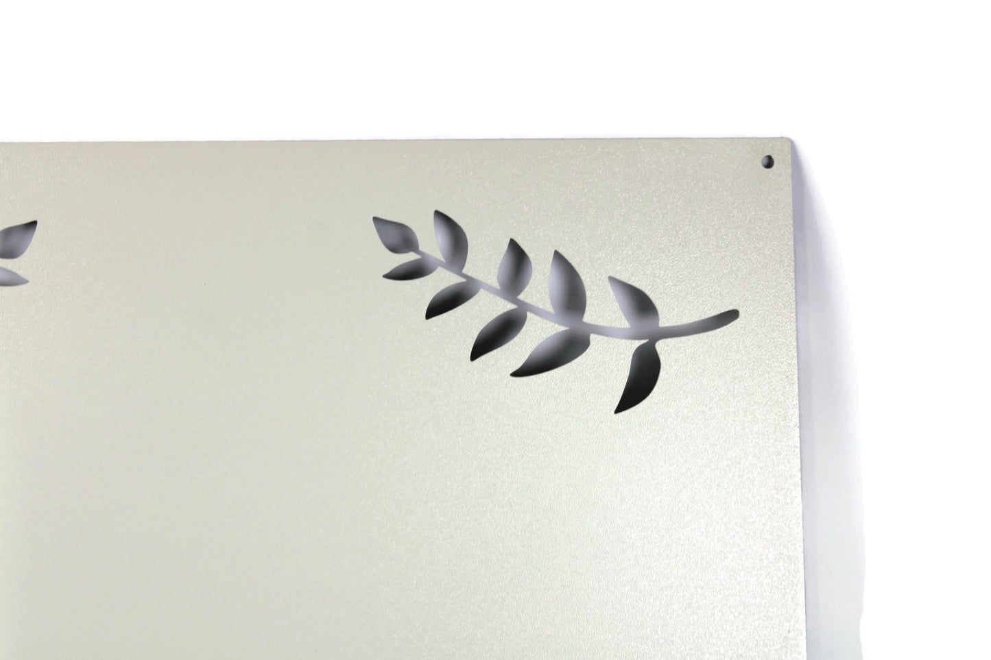 Cream powder coat metal magnet message board with leaf pattern close up
