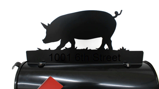 Black pig custom mailbox topper installed on a mailbox