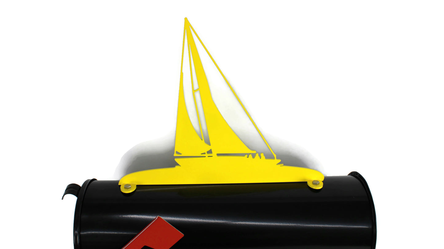 Yellow sailboat mailbox topper installed on a mailbox