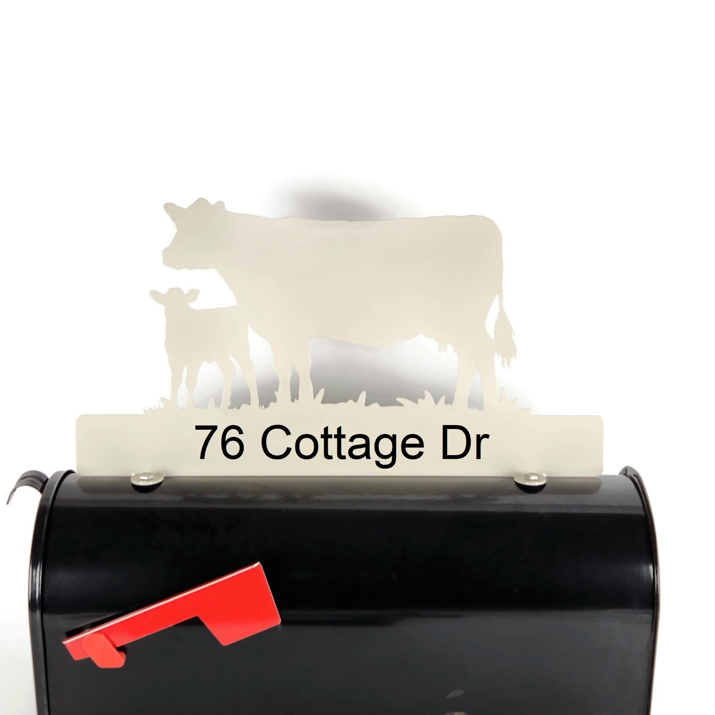 Cream cow and calf standing mailbox topper with custom address installed on a mailbox.