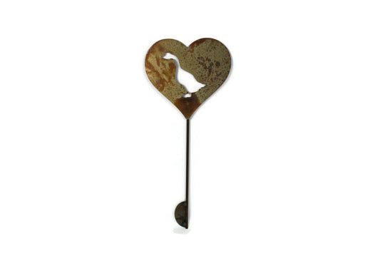 Heart-shaped rusty garden stake sign in rust with a goose silhouette
