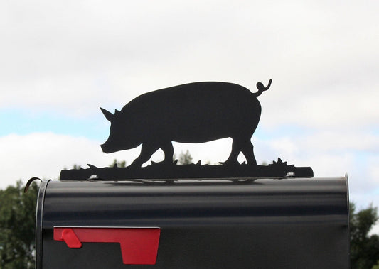 Black pig mailbox topper installed on a mailbox