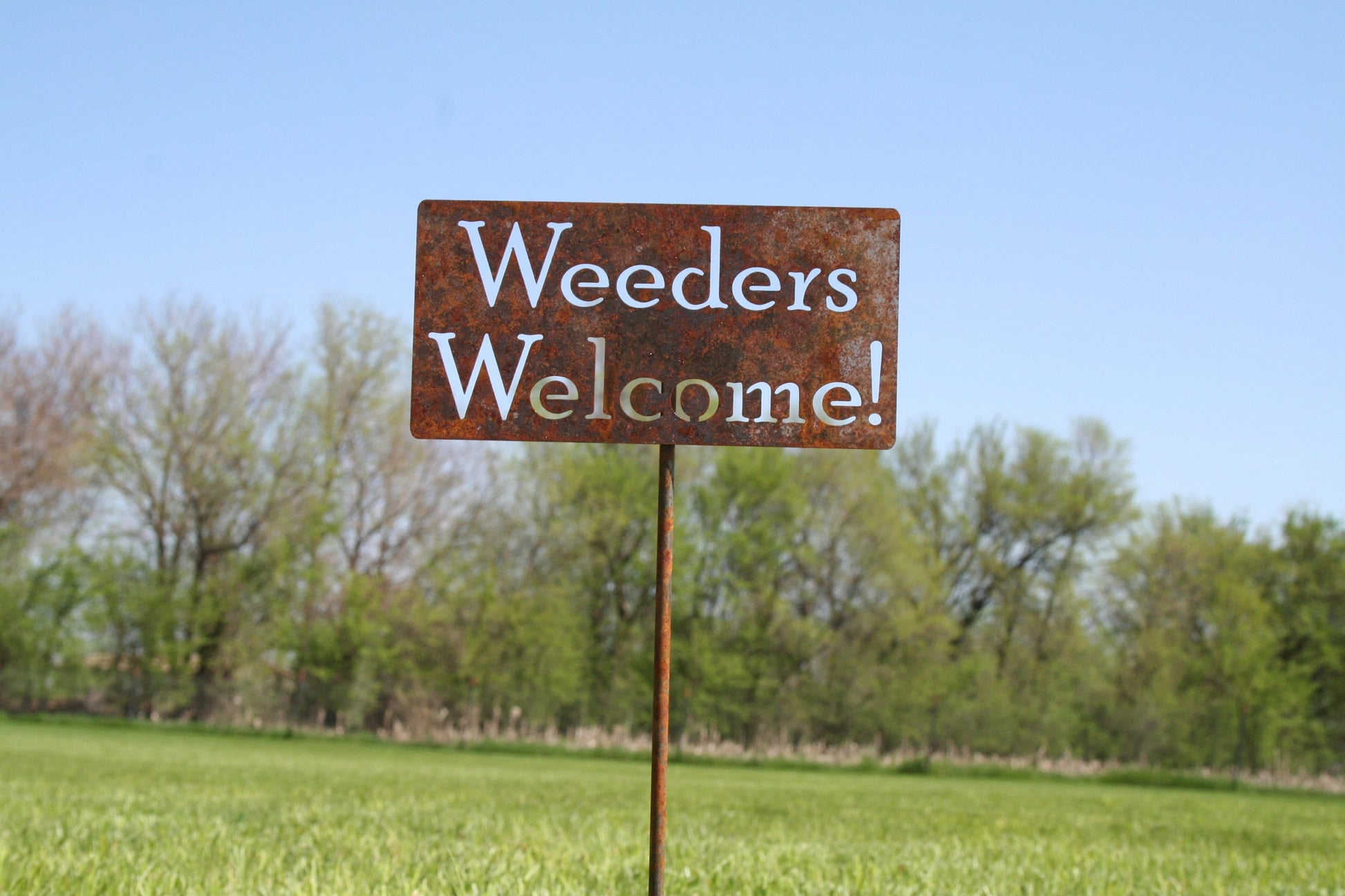 Weeders Welcome rusty garden stake sign