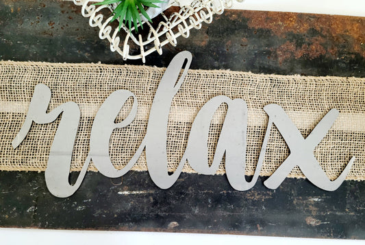 relax metal script word sign in raw steel