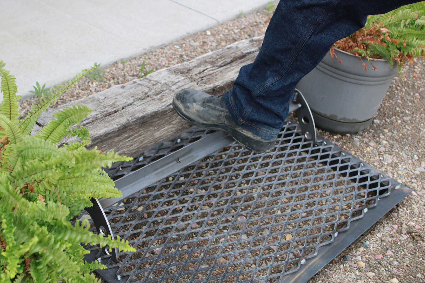 Work shoe being scraped on a steel boot scraper