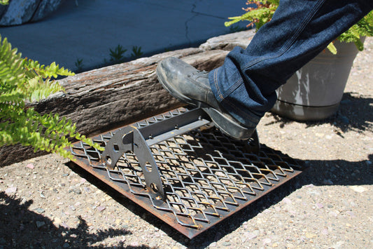 Work shoe being scraped on a steel boot scraper