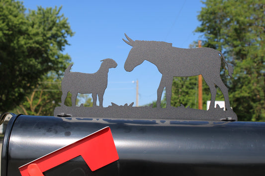 Black donkey and goat mailbox topper installed on a mailbox.