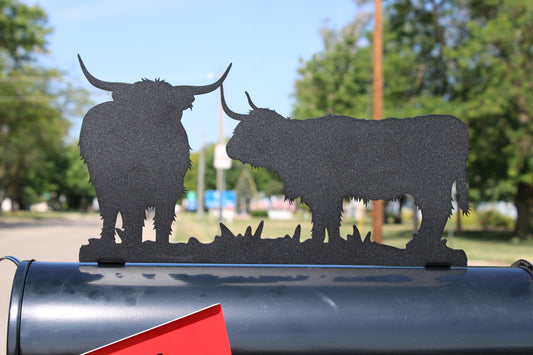 Black highland cattle mailbox topper installed on a mailbox