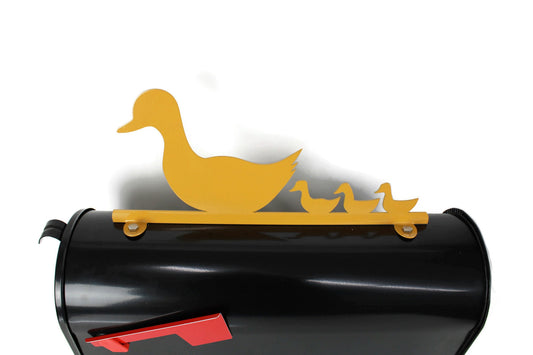 Dark yellow duck and ducklings mailbox topper installed on a mailbox.