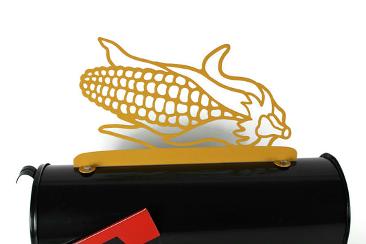 Yellow ear of corn mailbox topper installed on a mailbox.