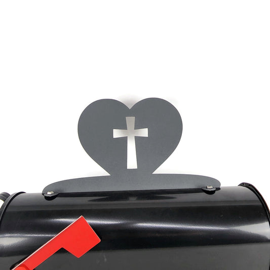 Dark stone gray cross and heart mailbox topper installed on a mailbox.