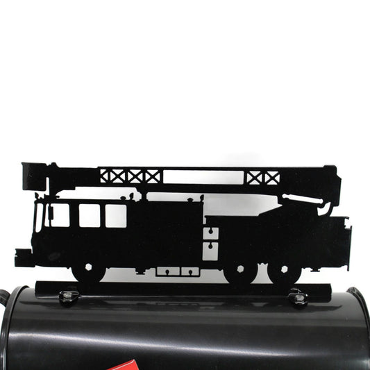 Black fire truck mailbox topper installed on a mailbox.