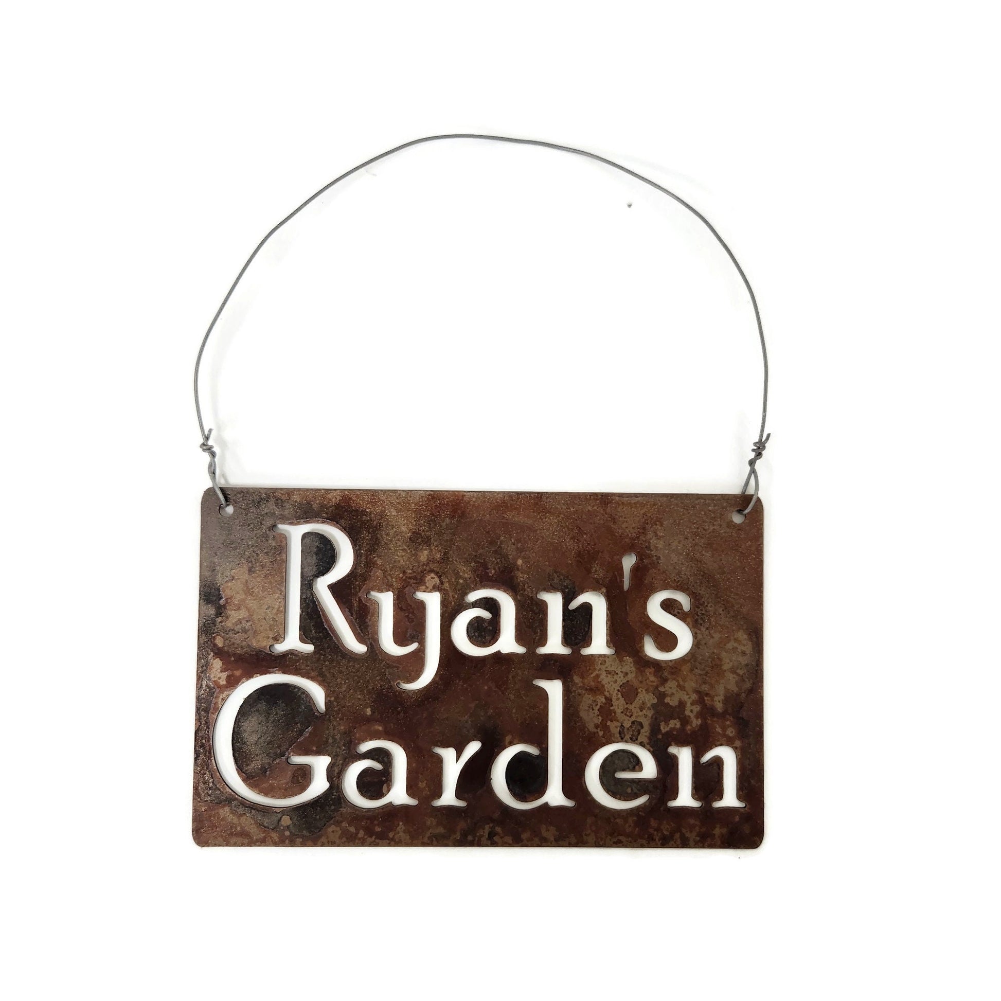 Custom hanging garden sign in rust with a wire hanger and Ryan's Garden for text