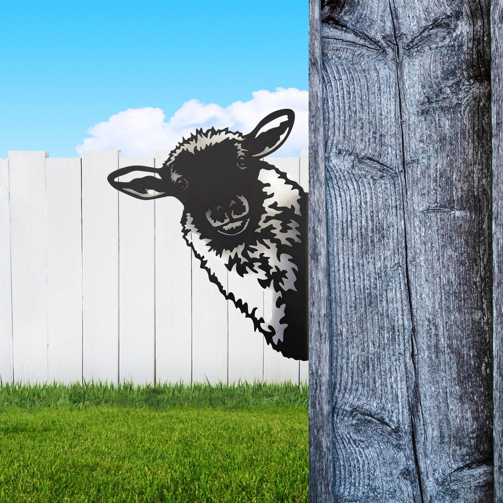Black powder coat metal sheep head peeking around a tree