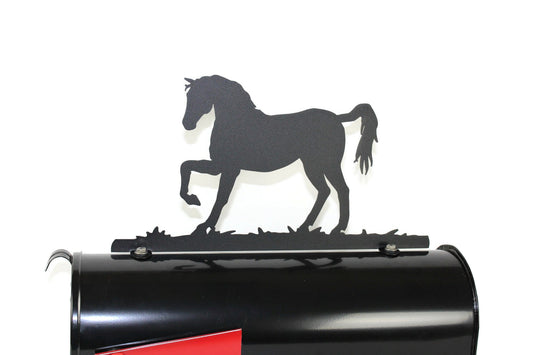 Black standing horse mailbox topper installed on a mailbox
