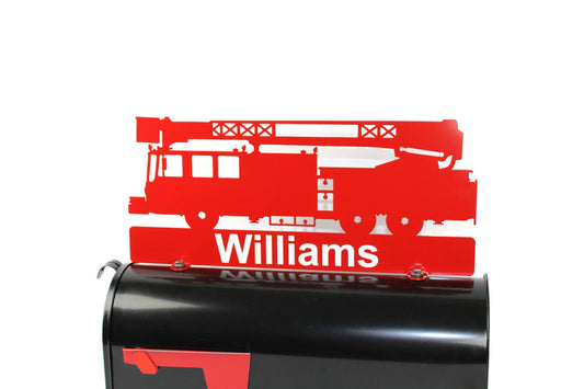 Red fire truck custom mailbox topper with address installed on a mailbox.