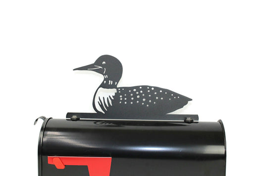 Black loon bird mailbox topper installed on a mailbox.