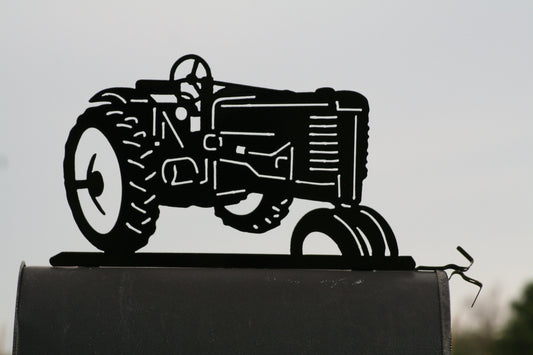 Black vintage tractor mailbox topper installed on a mailbox