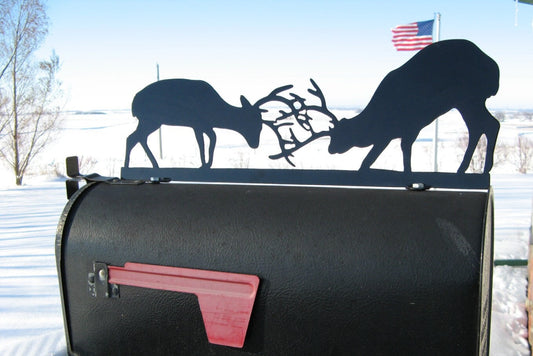 Black fighting deer mailbox topper with address installed on a mailbox.