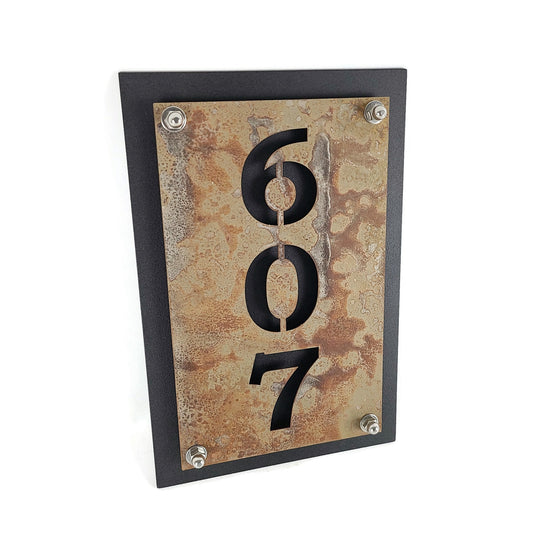 Rust over black vertical layered metal address sign