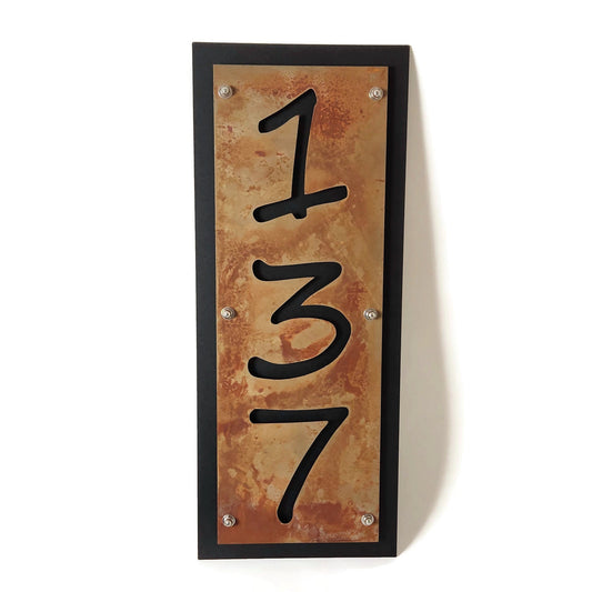 Rust over black vertical layered metal address sign