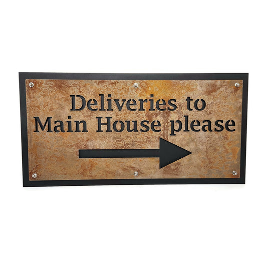 Rust over black layered metal direction sign