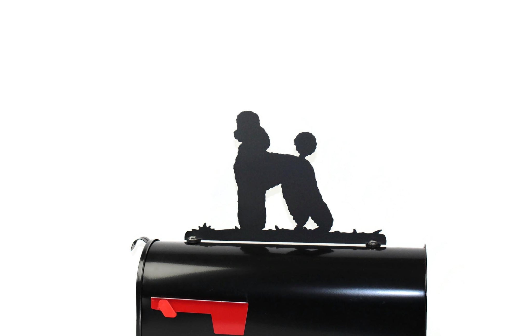 Black poodle mailbox topper installed on a mailbox