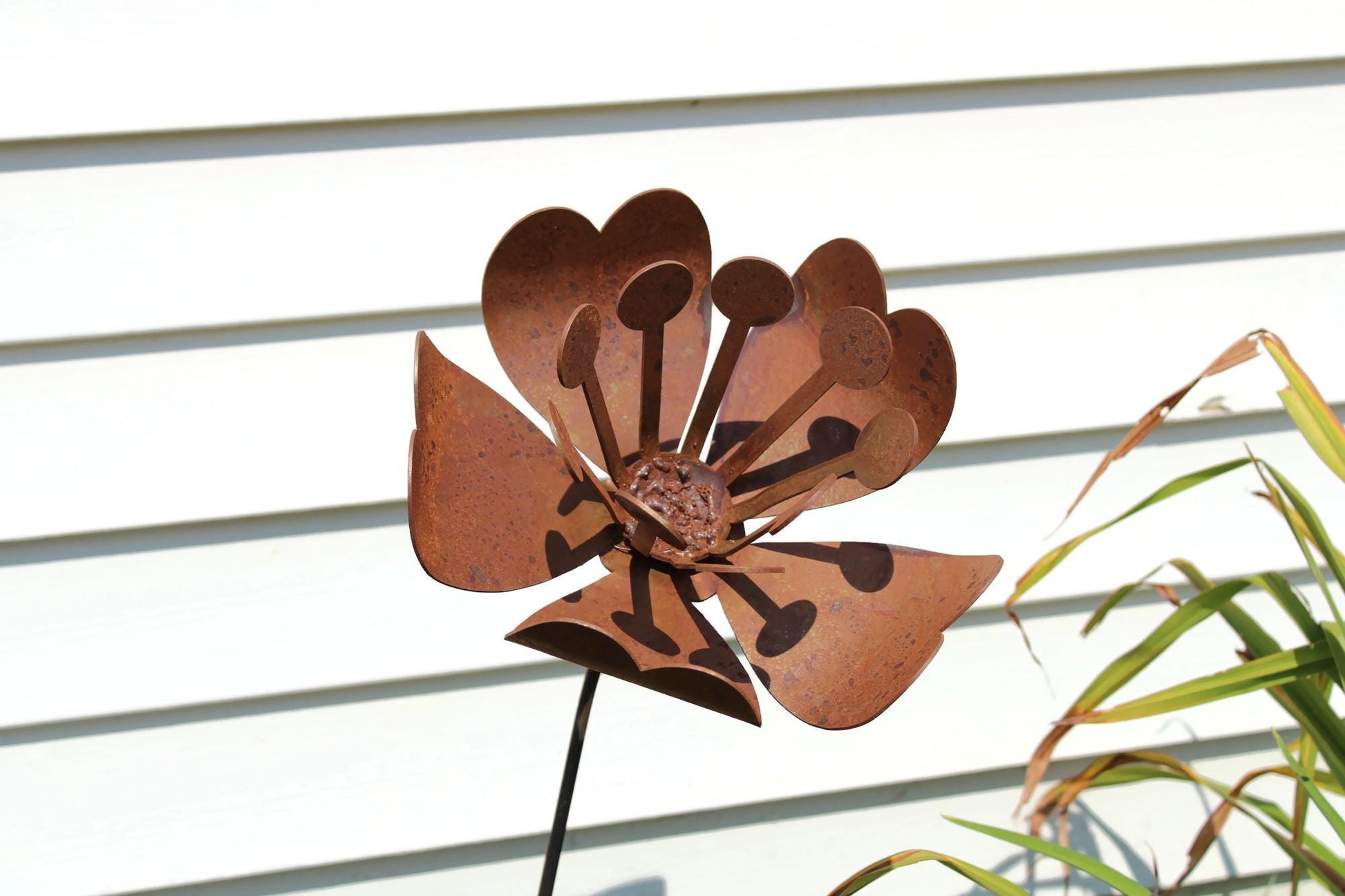 Daffodil and magnolia flower inspired rusty metal garden stake