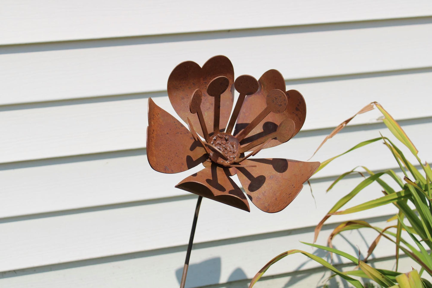 Daffodil and magnolia flower inspired rusty metal garden stake