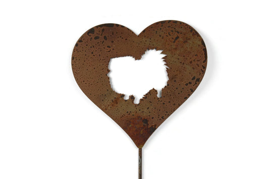 Heart-shaped rusty garden stake sign in rust with a pomeranian dog silhouette