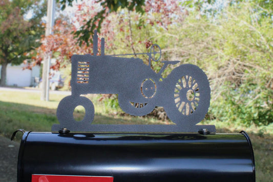 Black vintage tractor mailbox topper installed on a mailbox