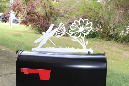 White dragonfly and daisy mailbox topper installed on a mailbox.