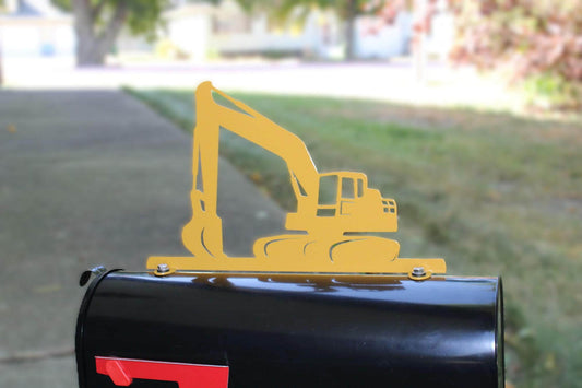 Yellow excavator mailbox topper installed on a mailbox.