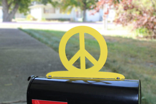Yellow peace sign mailbox topper installed on a mailbox