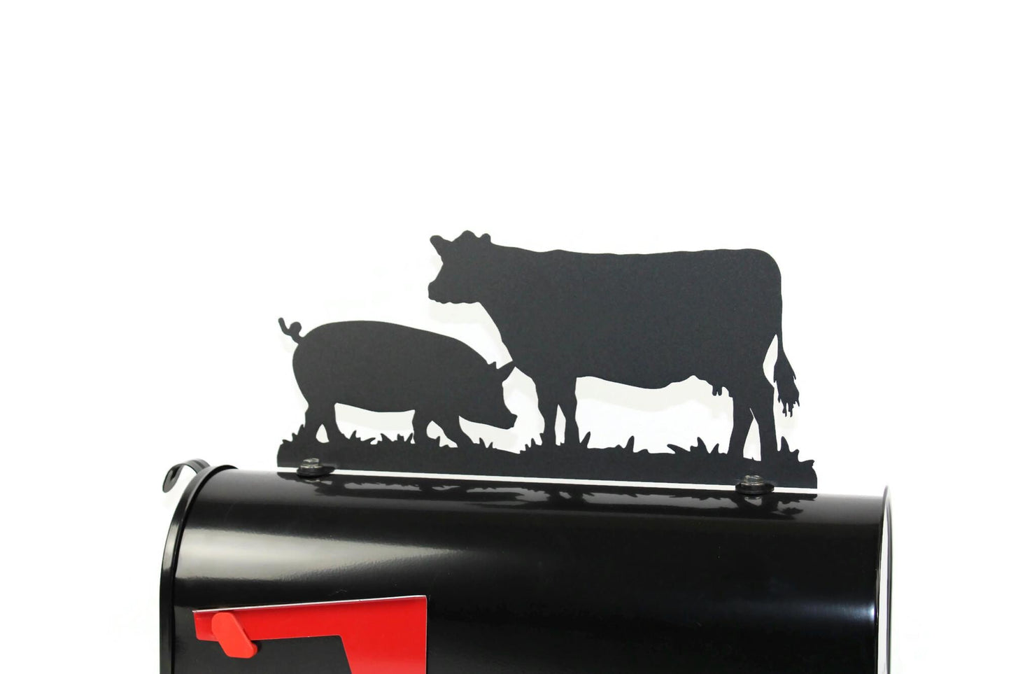 Black cow and pig mailbox topper installed on a mailbox.