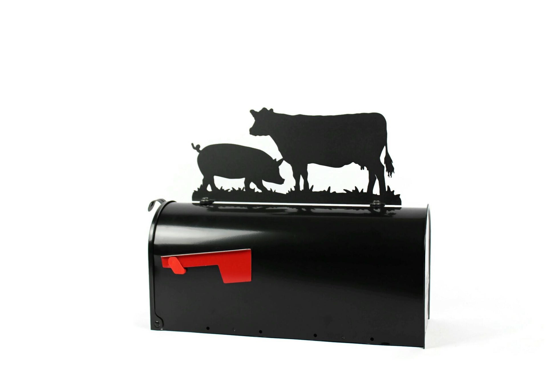 Black cow and pig mailbox topper installed on a mailbox.