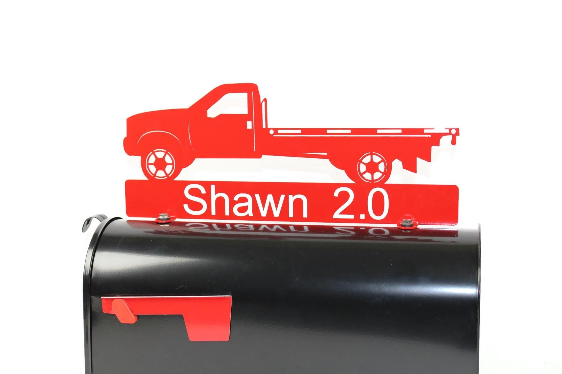 Red flatbed truck mailbox topper with name installed on a mailbox.