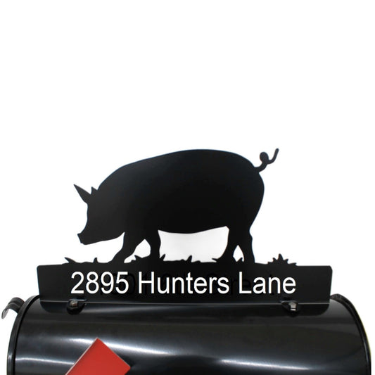 Black pig custom mailbox topper installed on a mailbox